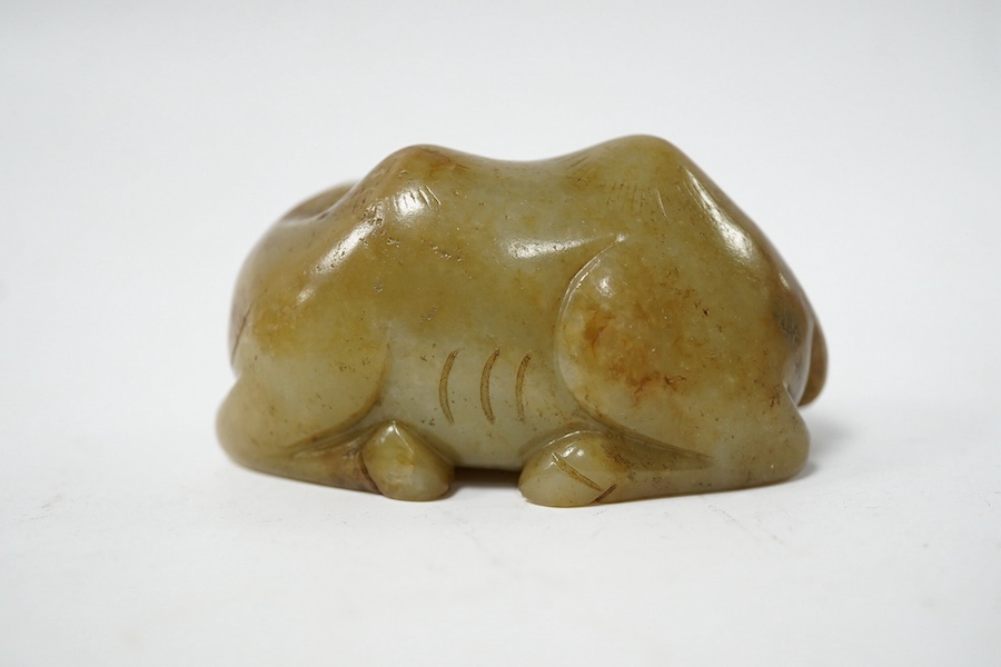 A Chinese carved jade figure of a recumbent Bactrian camel, 7.5cm long. Condition - good